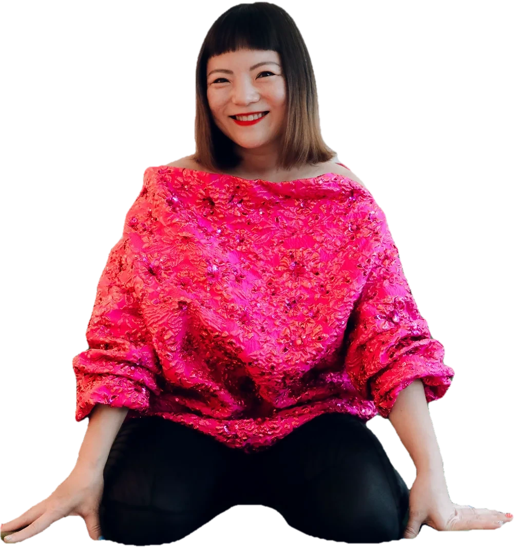Simone Grace Seol, smiling, in a pink sequined top